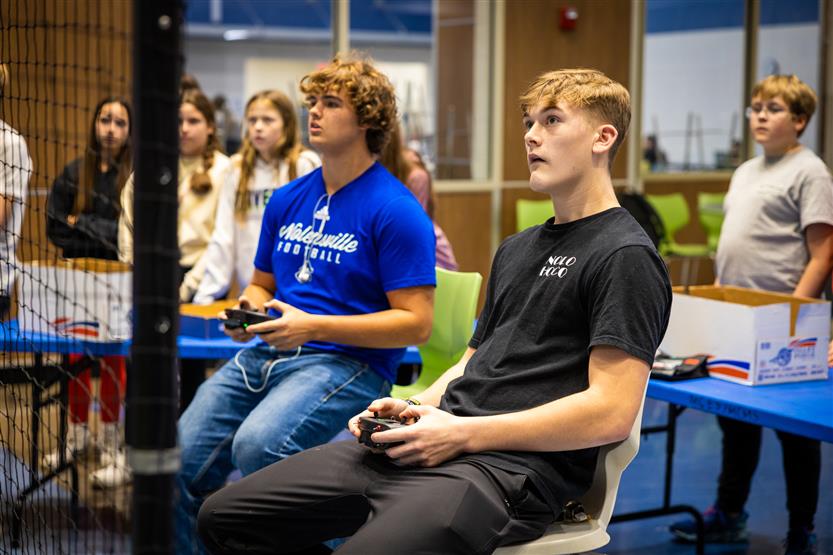Middle and high school students learning about drone soccer